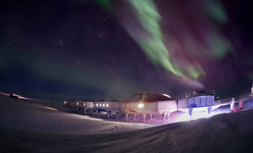 winter aurora borealis over the Halley VI research station in Antarctic
