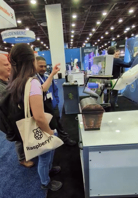 ai rock paper scissors demo with cobot, user wins and receives a brainboxes branded screwdriver from chest